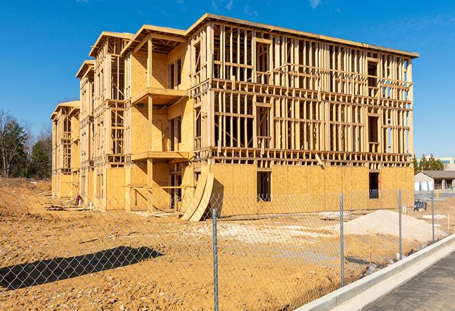 construction zone secured with a temporary fence, marked with warning signs in Edwardsville